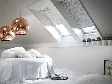 VELUX blinds installed onto pitched roof windows in converted loft bedroom